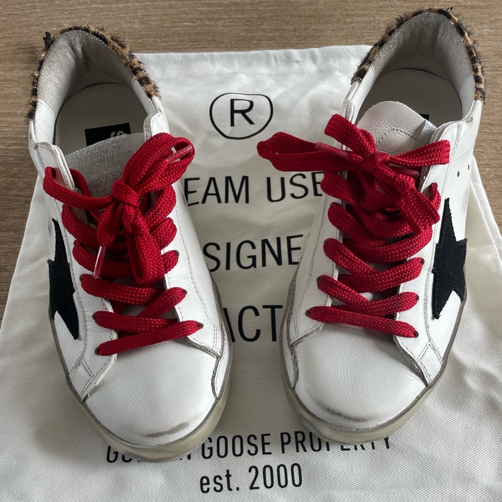 Black star, cheetah ankle and red laced Golden Goose.